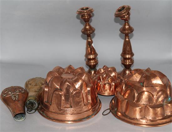 A pair of copper candlesticks and jelly moulds, etc.